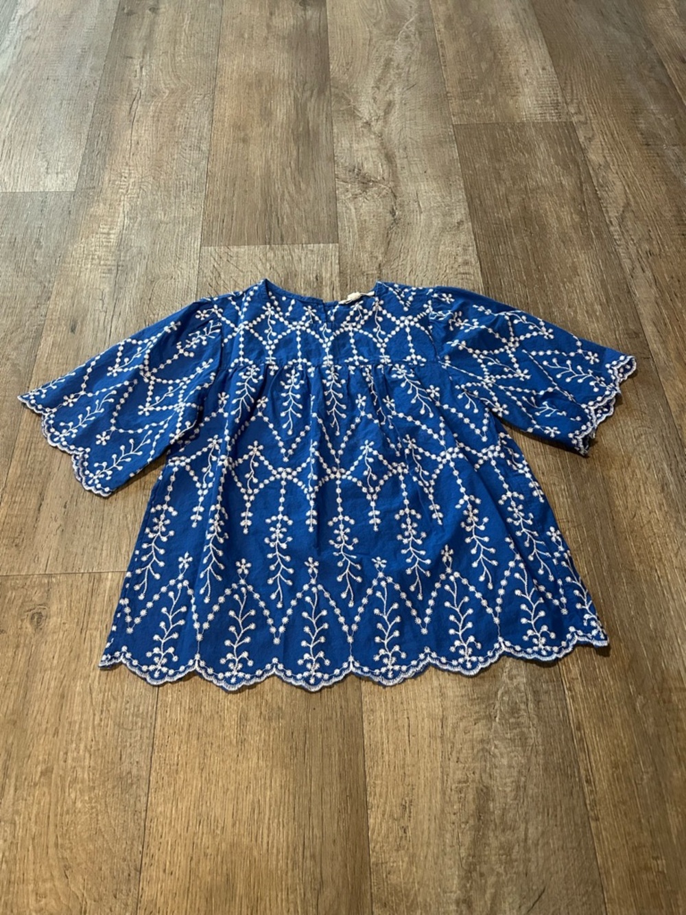 Blue Embroidered Peasant Blouse with White Floral Detailing and a Scallop Hem